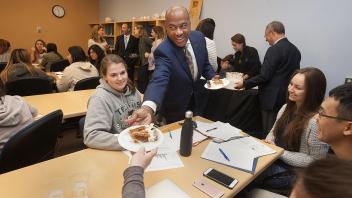New Chancellor Gary May talks with students as he hands out cake after their professsor Dave Rizzo won the UC Davis Teaching Prize on April 14, 2017.