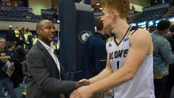 Chancellor May congratulates men's basketball player Siler Schneider.	